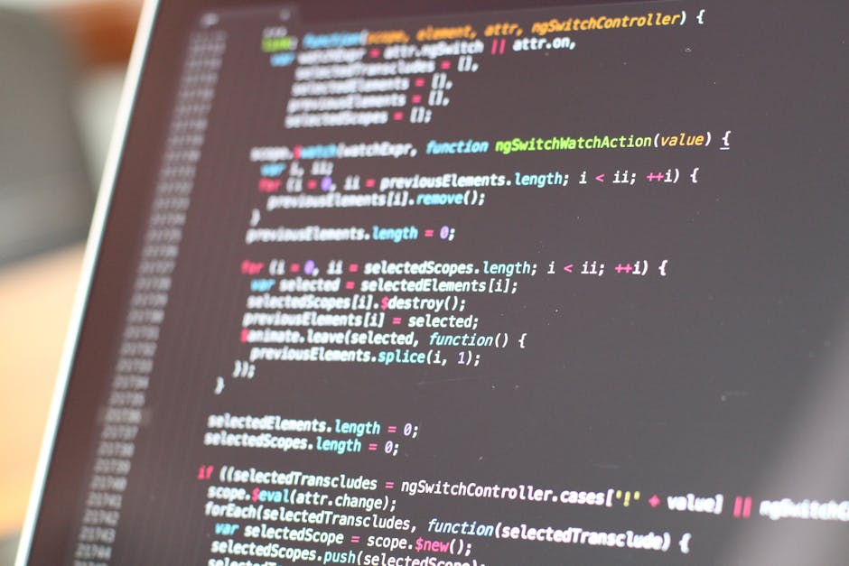 A close-up view of a computer screen displaying lines of colorful programming code, including keywords, variables, and functions in various shades of pink, blue, green, and white on a dark background.